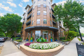 a rendering of a building with a flower bed in front of it