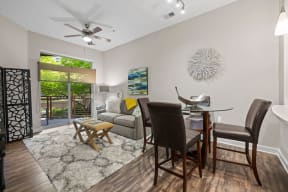 a dining room and living room with a table and chairs