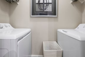 a washer and dryer in a laundry room with a window