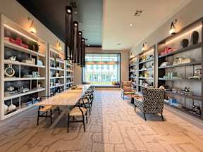 A modern interior with a long table and chairs.