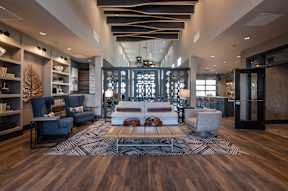 A modern living room with a large sofa set and a coffee table.