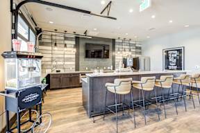 A bar area with a bike and chairs.