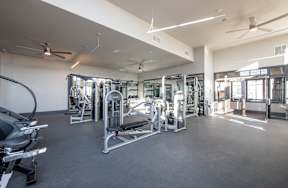 A spacious gym with a variety of equipment.