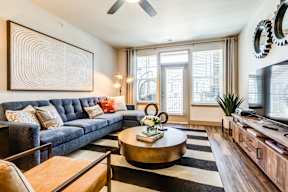 A living room with a blue couch and a coffee table.