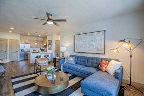A living room with a blue couch and a coffee table.