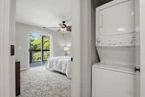A white washing machine is in a laundry room.