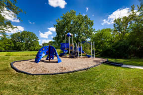 children's playground with blue sliding and a climbing wall