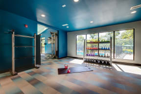 kettle ball rack by a large window inside The Bennington Apartment's fitness center