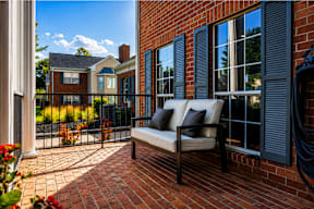 A patio with a couch and a chair is shown.