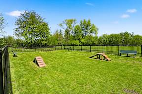 A fenced yard with a picnic table and bench.