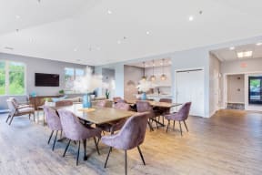 dining tables with purple velvet chairs in the Eagle Creek Apartments resident lounge