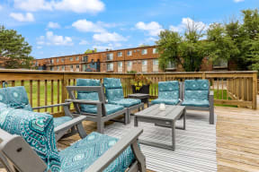a deck with chairs and a table