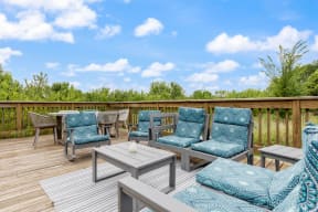 gray outdoor furniture with blue cushions on a wood deck