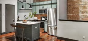 Houston apartment kitchen with sage cabinets and stainless steel appliances