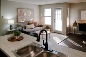 open concept apartment home with a kitchen island overlooking the living room