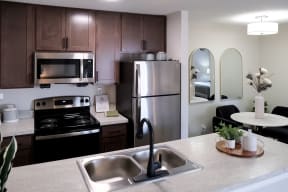 updated kitchen with a dining nook at an Addison at Southfield apartment home