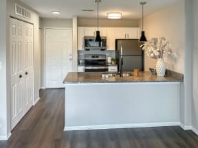 a kitchen with white cabinets and a peninsula 