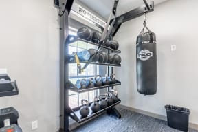 weight rack and punching bag in Littlestone Apartments fitness center
