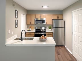 The Magnolia apartment kitchen with stainless steel appliances