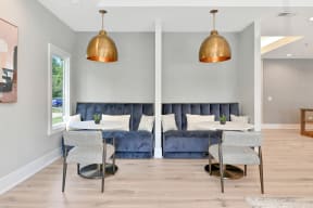 blue velvet booth seating under copper pendant lighting in the Farmington Lakes clubhouse