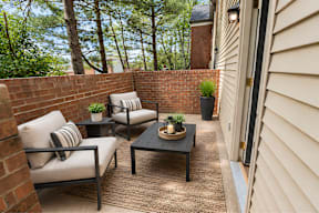 A patio with a table and chairs.