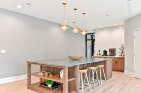 large island with shelving and three barstools
