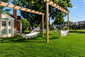 A white hammock is suspended between two wooden posts.