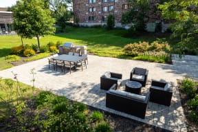 a patio with a table and chairs and a fire pit