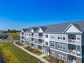A modern apartment building with balconies and a clear blue sky.