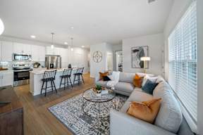 A modern living room with a grey sofa and a coffee table.