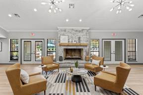 A living room with a fireplace and chairs.