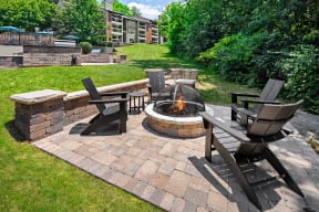 an outdoor patio with a fire pit and patio furniture