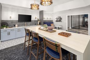 a kitchen with a large table and chairs