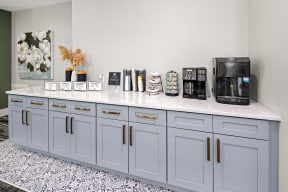 a kitchen counter with coffee machines and other items on it