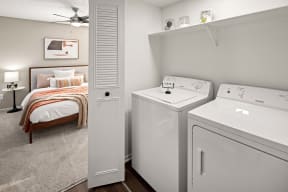 washer and dryer in a laundry room off the bedroom
