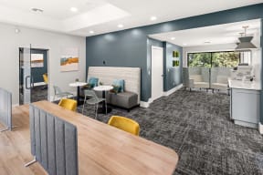 a common room with a kitchen and lounge area at the enclave at woodbridge apartments in sugar