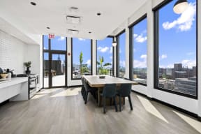 large dining table by a coffee bar at Atrio Apartments in Chicago