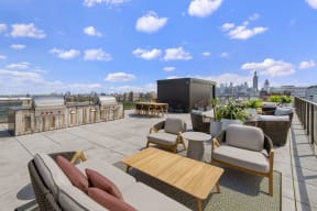 rooftop lounge with a seating area and grilling station