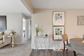 a living room with beige walls and a white table with a plant on it