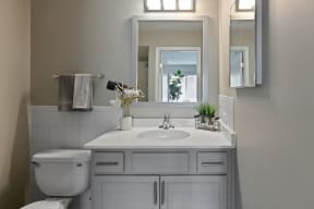 a small bathroom with a toilet sink and mirror