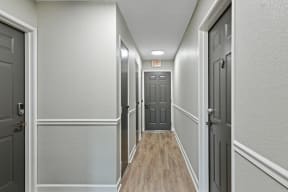a hallway with gray walls and white trim