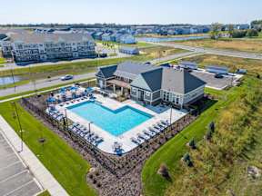 A large swimming pool with a building next to it.
