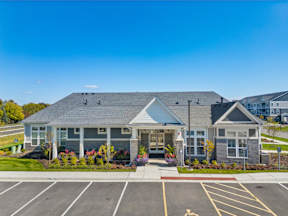 A building with a parking lot in front of it.
