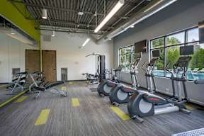 A gym with treadmills and elliptical machines.