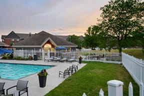 Valley Creek Apartments swimming pool surrounded by a sundeck and lawn