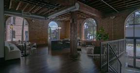 A large open space with a high ceiling and wooden floors.