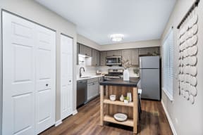 a spacious kitchen with stainless steel appliances and a wooden island