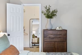 a living room with a couch and a dresser and a mirror