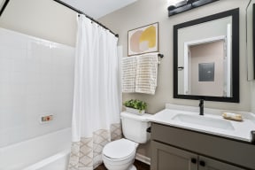 a bathroom with a shower and a sink and a toilet