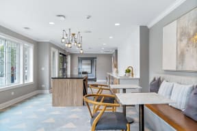 a living room with a kitchen and a table and chairs